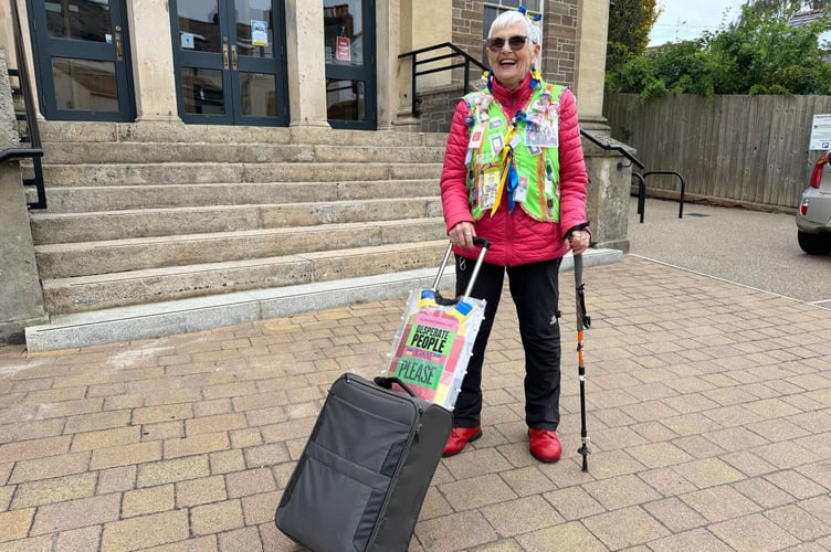Heather Sansom, wearing her fluorescent jacket with her flight case in which she collects donated items to send to Ukraine.  AQ 3436
