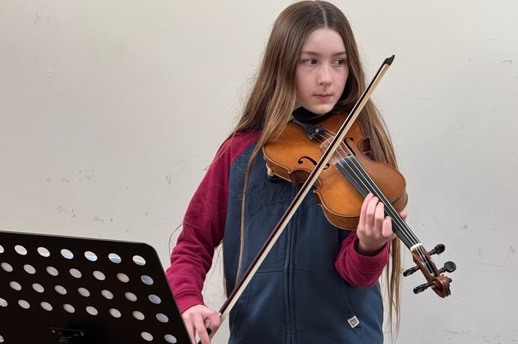 Crediton Youth Orchestra member Flora Cornthorn (11), played the violin at the Seed Share.  AQ 4430

