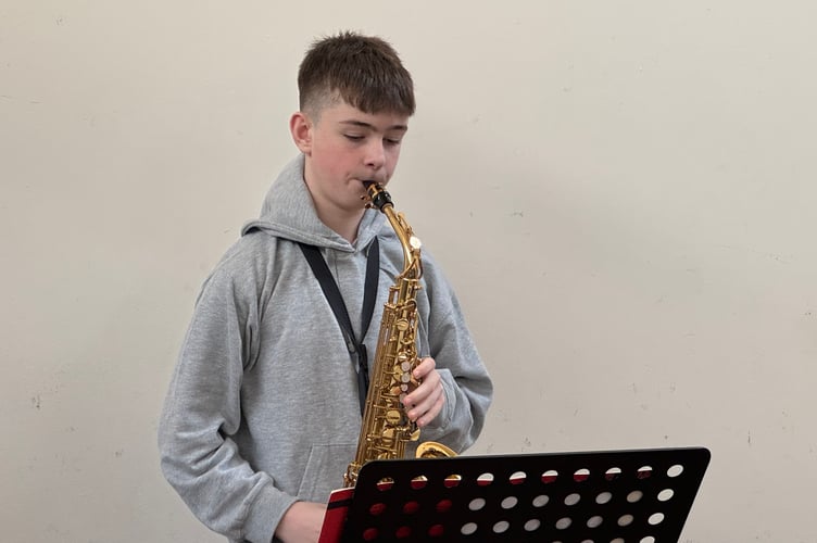 Reuben Morgan (12), a member of Crediton Youth Orchestra, performed at Sustainable Crediton Seed Share.  AQ 4419

