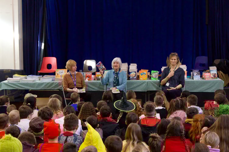 Bookery volunteers read books from the collection to pupils