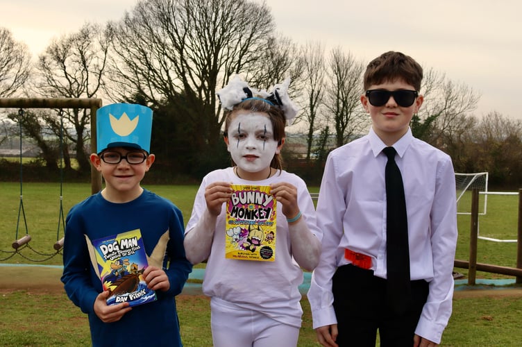 Children dressed up with books