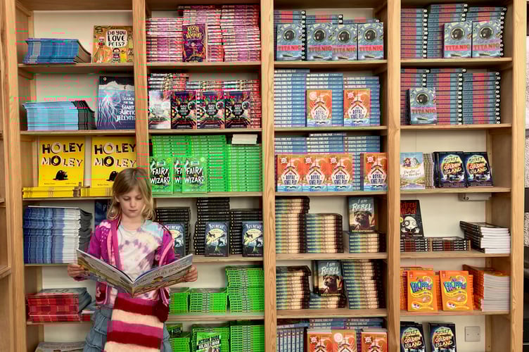 A six-year-old selecting from the Bookery's Top Titles