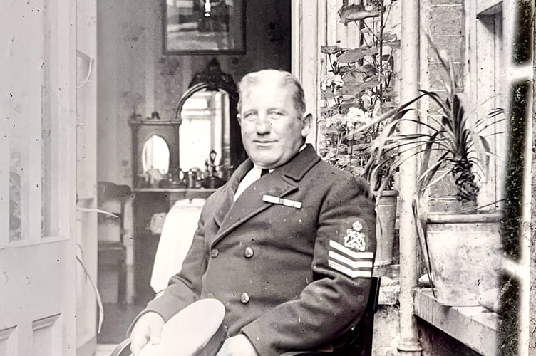 A man seated. Possibly a petty officer in the Royal Navy