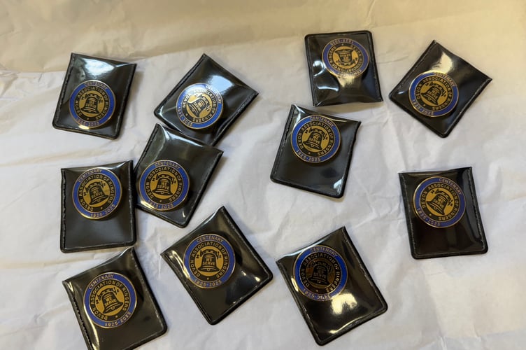 Some of the Anniversary Devon Association of Bellringers badges on sale.  AQ 5658
