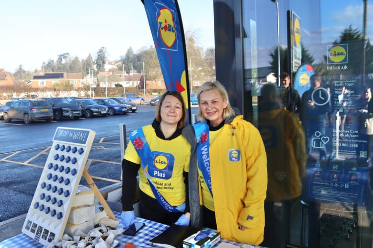 Staff offering a promotional game outside the store