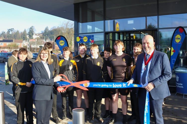 Crediton RFC Chairman Liz Goodman with some of the U15s and Deputy Mayor Steve Huxtable at the official opening