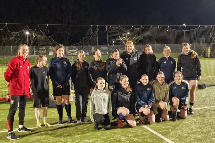 Crediton Youth Girls sides had two special guests recently at their Friday night training sessions.  Bow Jackson, left, and Jess Sandland, standing fourth right, from Exeter City FC ladies team went along and actively got involved in many of the training sessions taking part that evening.
