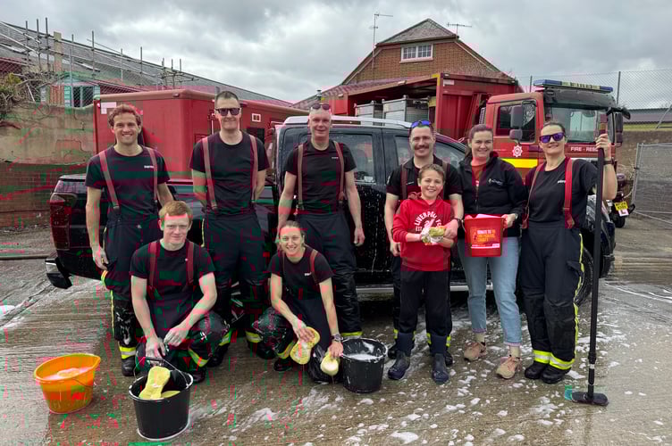 Some of the Crediton firefighters who took part in the charity car wash. AQ 7600
