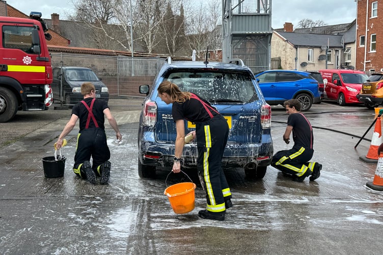 All hands to the pump to clean another car at Crediton Fire Station. AQ 7591
