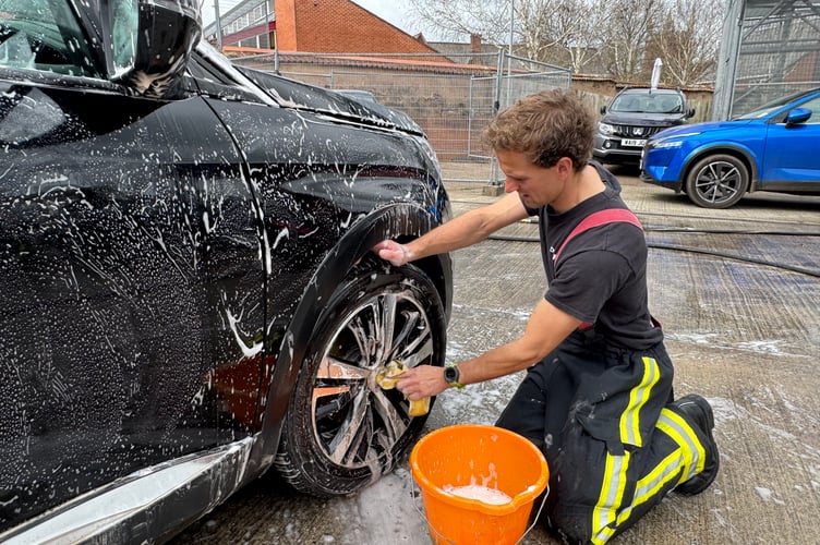 Finishing touches made to clean another car at the Fire Station car wash. AQ 7613
