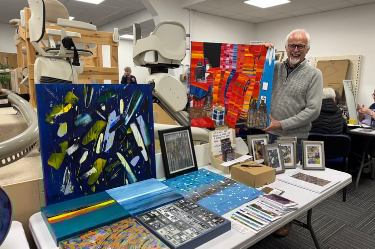 Abstract Artist Phil Smith with his stall of works at the Bake Sale.  Phil has a semi-permanent exhibition of some of his works on display in the Dolphin Stairlifts showroom.  AQ 7899
