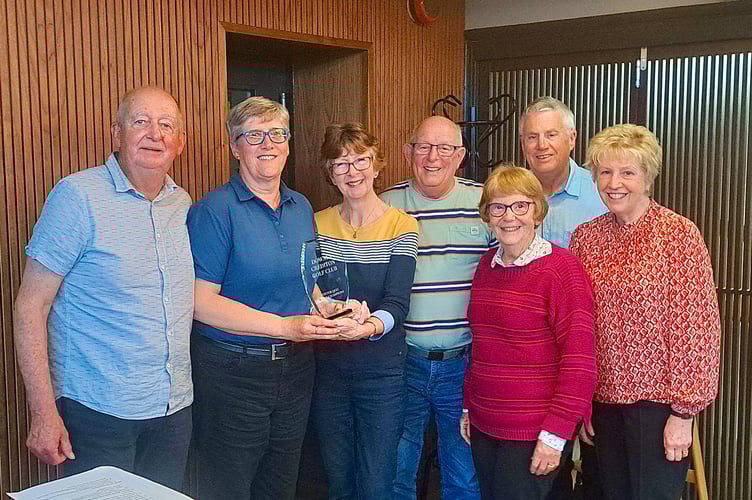 The winning Winter Quiz team with the Captain Anne Woodger, second left, being presented with the trophy by Debbie Blinkhorn. 
