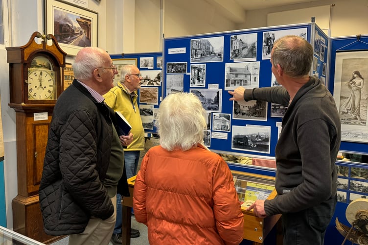 Looking at some old images in Crediton Museum.  AQ 8363
