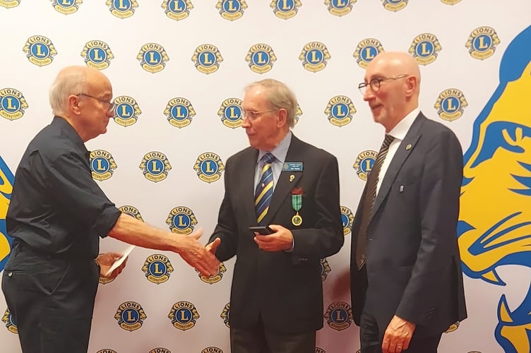 Eric Parkes, centre, receiving the Lions Club International President’s award from, left, Lions South West District Governor Kevin Moore with, right, Lions International Director Marcel Daniels.