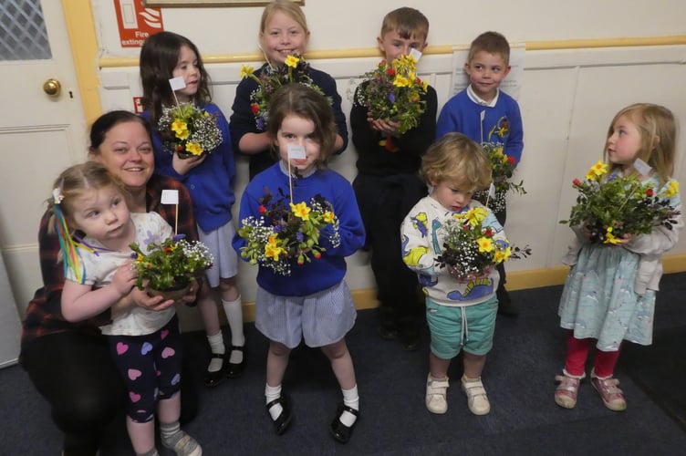 Prior to the Cheriton Fitzpaine Garden Club Spring Exhibition, a Children's Workshop was organised in the Village.  Pictured are the children, the youngest three years old, with helper Schnare Taylor-Shorland.
