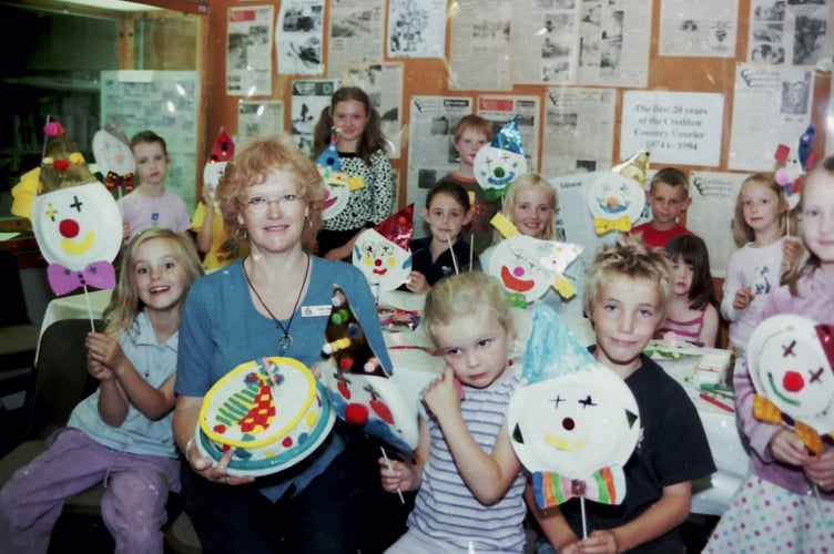 Children made clown masks at Crediton Library and during the event a clown decorated birthday cake was presented to Anne Logan, Library Assistant in August 2004. DSC01792