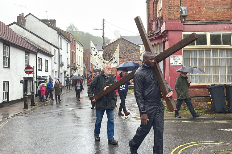 Volunteers carrying cross down North St to the Town Square