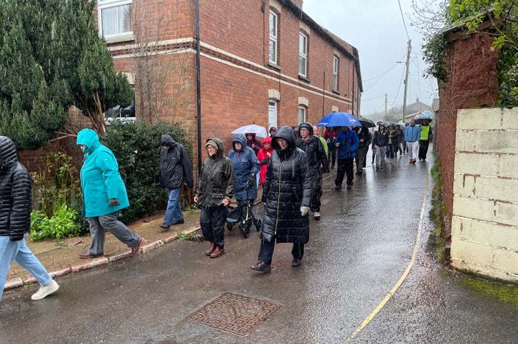 Procession on Dean St in heavy rain