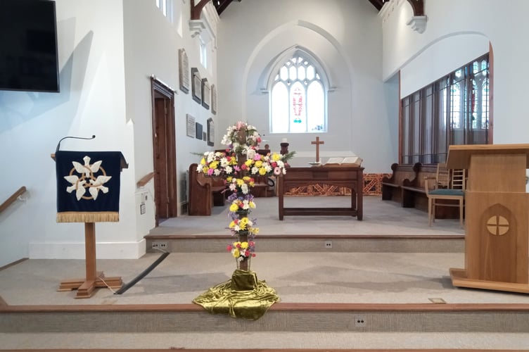 Members of the congregation brought flowers to decorate the cross at Crediton Congregational Church.
