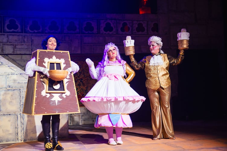 Cogsworth played by Steph Morgan, Mrs Potts played by Buffy May and Lumiere played by Holly Harris, on stage for CODS Beauty and the Beast. Image: Rory Oliver
