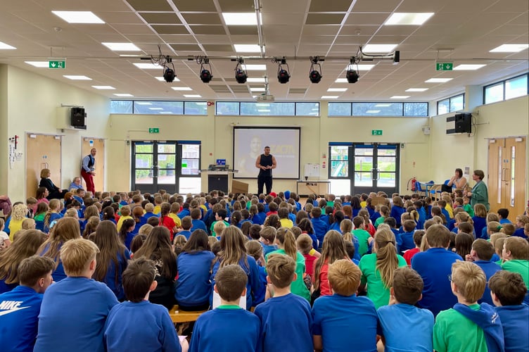 Mr George speaking to Landscore pupils