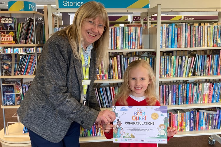 24 April 2025 Secret Book Quest finisher Amber with Crediton Library Supervisor Sue Lee (Will Goddard, Crediton Courier)