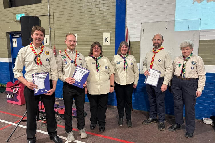 Award recipients, left, John Dunning and Howie Squires and fifth left, Robin Thorpe, all leaders at Tedburn and Cheriton with female leaders Karen Squire and Debbie Richards, centre and Elinor d’Albiac, right. AQ