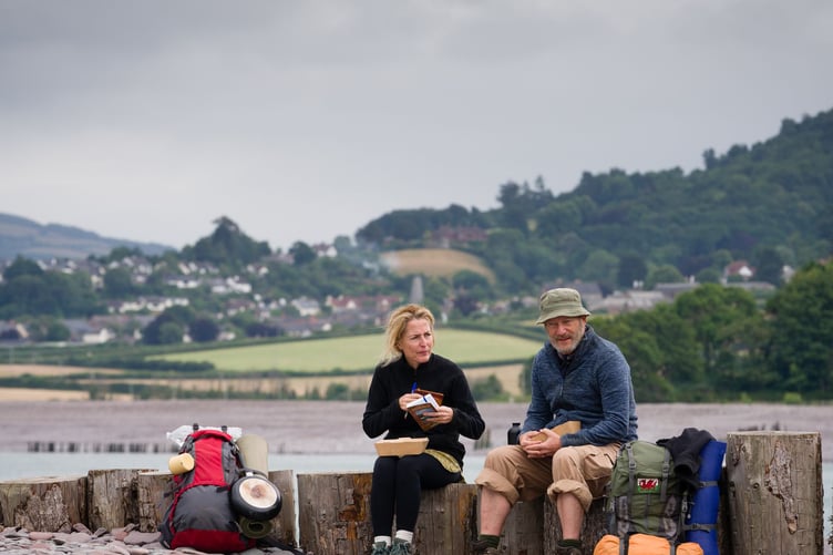 Gillian Anderson and Jason Isaacs taking a break as walkers Raynor Winn and husband Moth based on their South West Coast Path walk.  Picture by Steve Tanner.