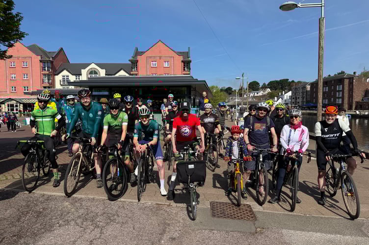 Tom, centre, with his supporters who joined him on his charity cycle ride in Exeter.  AQ 9474
