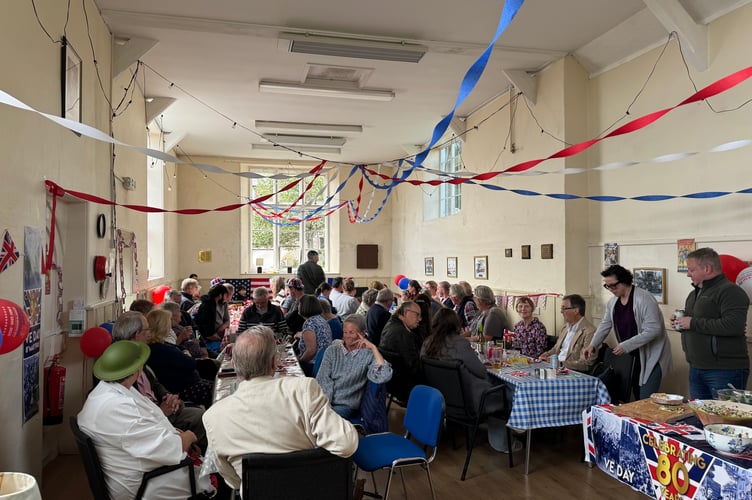 Poughill Village Hall was decorated and tables filled for the VE Day 80th Party. AQ 0577