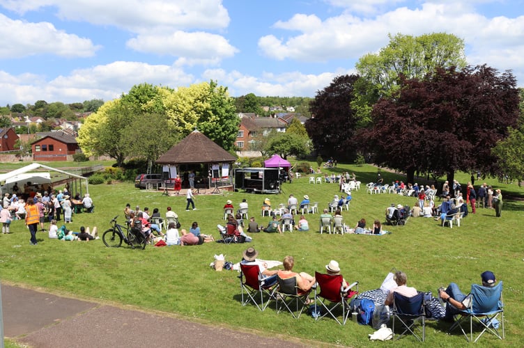 Picnic-goers enjoying entertainment in Newcombes Meadow