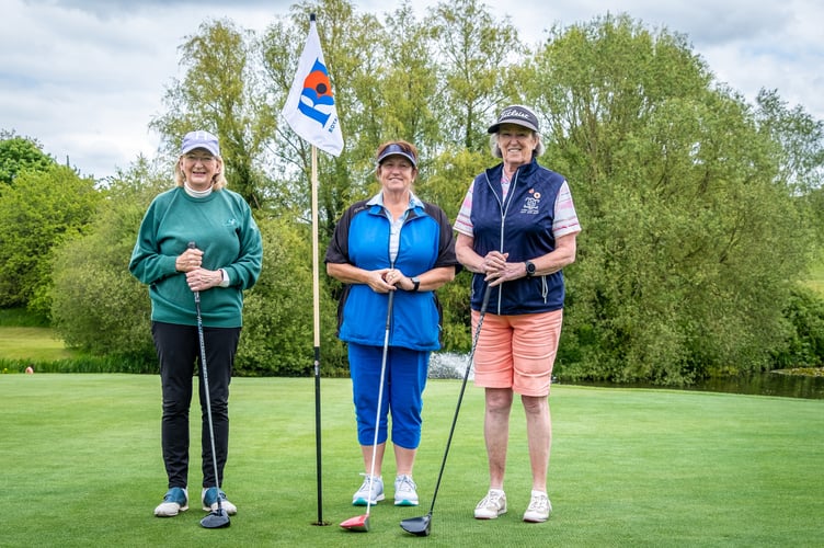 Ladies with the Royal British Legion flag proudly displayed on 18th green at Downes Crediton.
