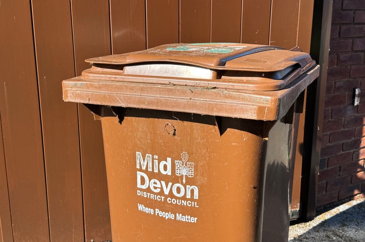 A Mid Devon District Council garden waste collection wheelie bin.  AQ 1440
