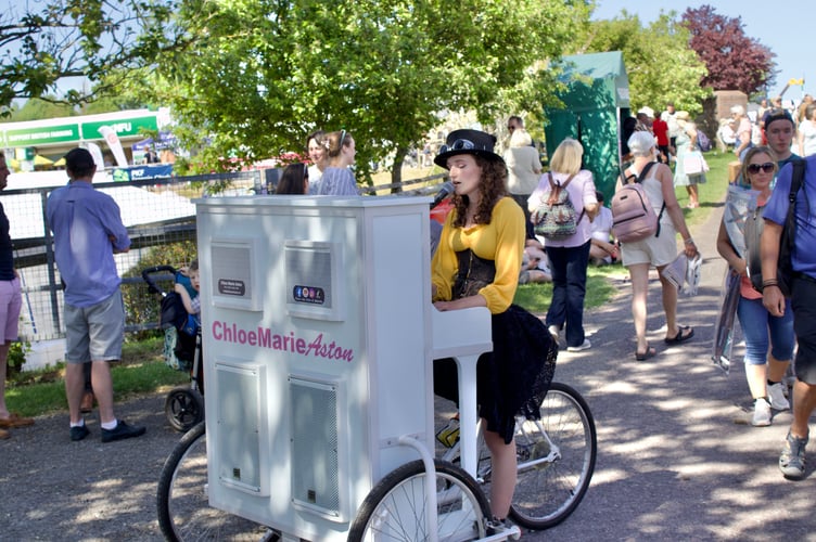 Chloe Marie Aston with her piano tricycle