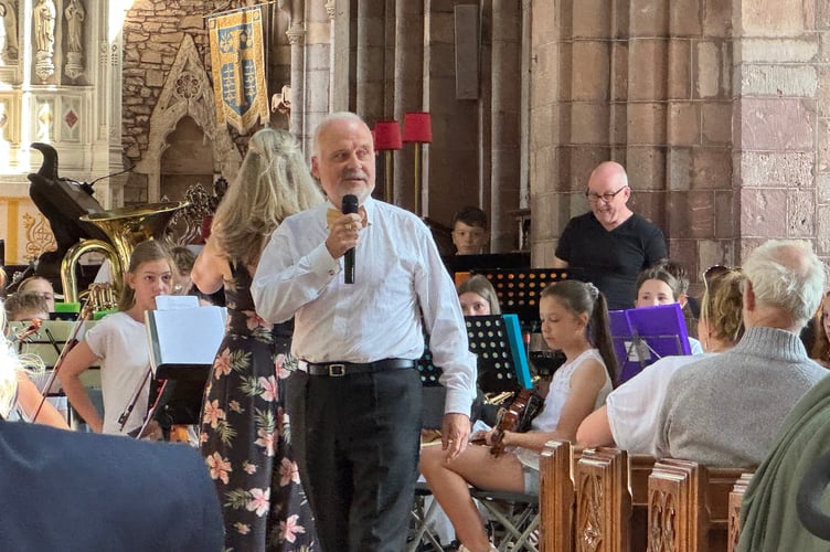 Crediton Town Band chairman Chris Richards welcomed the audience to the concert. AQ 2156