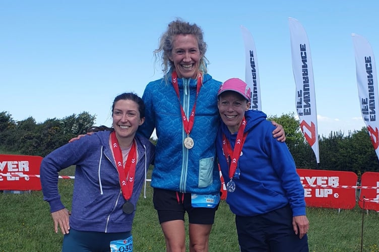 Natalie Rees, centre, on podium after winning the Endurance Life Half Marathon