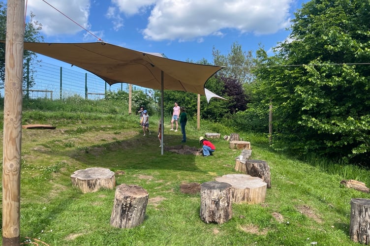Tidying up the outdoor classroom area at Cheriton Fitzpaine Primary School.