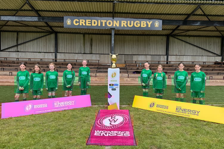 Newton St Cyres Primary School girls with the Women’s Rugby World Cup trophy. AQ 2363