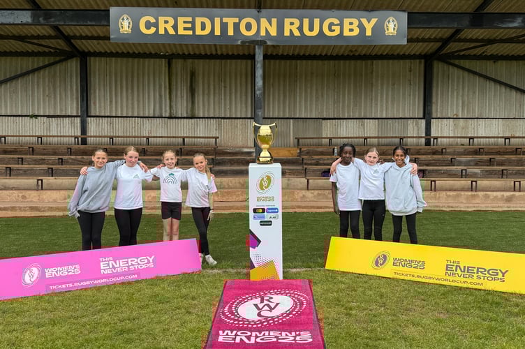 Stoke Hill Primary School girls with the Women’s Rugby World Cup trophy. AQ 2335