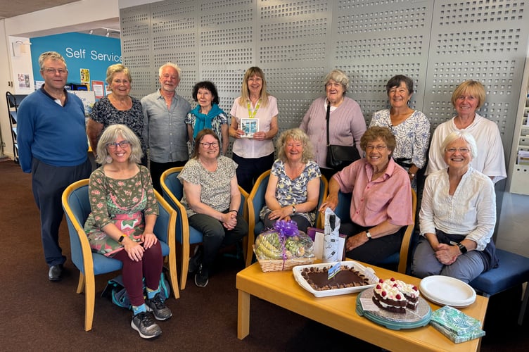 Retiring Crediton library supervisor Sue Lee, back row, fifth left, with members of Crediton Food Larder Group who held a tea party to say a fond farewell to Sue.  AQ 2854
