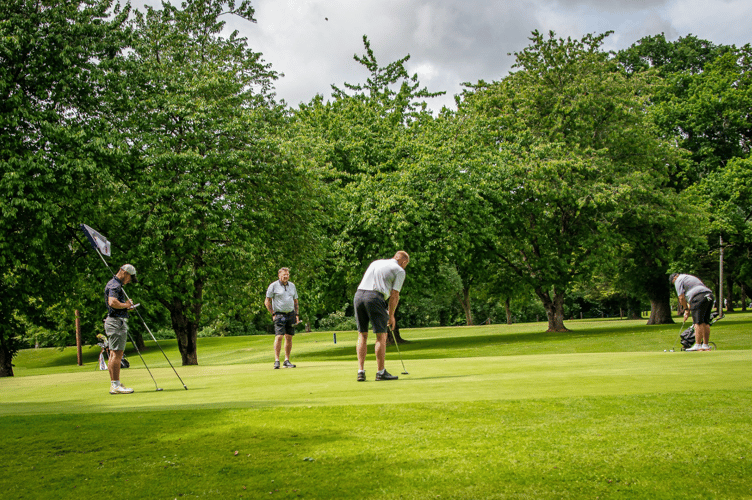 Putting out on the fourth hole