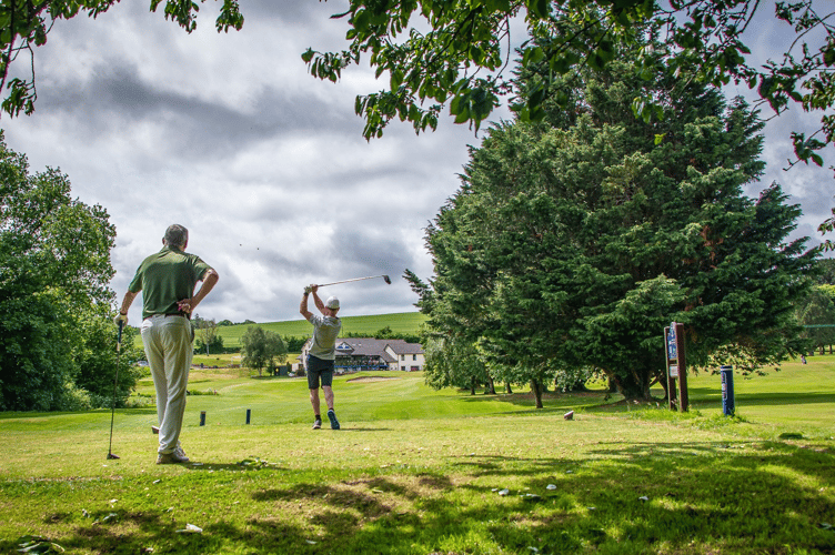Driving the par three 18th. Can you make the green?