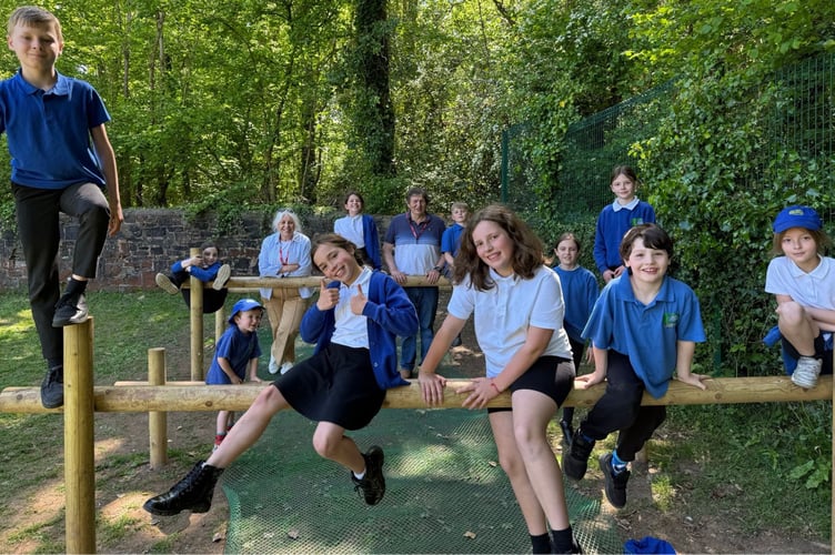 Yeoford pupils enjoying the new equipment with Jackie and Paul Coren, rear