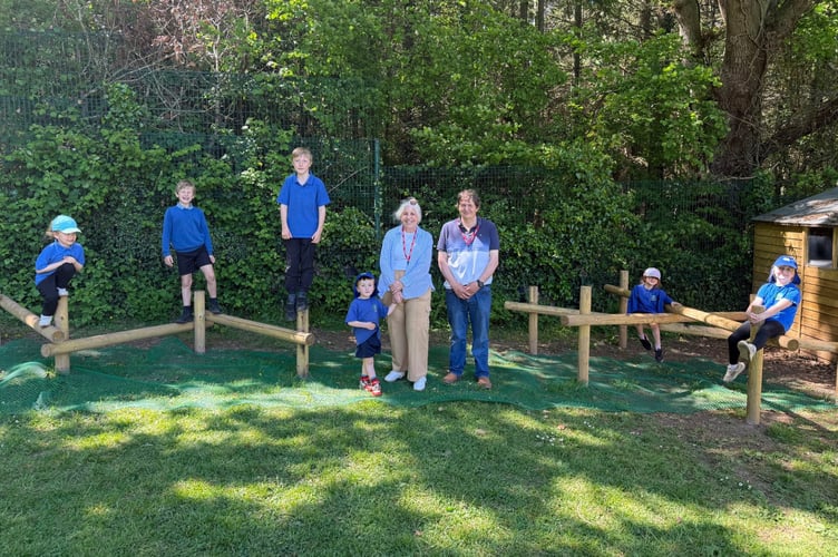 Jackie and Paul Coren of Yeoford Cricket Club with pupils on the equipment