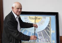 Crediton Parish Church's sundial being refurbished and repainted