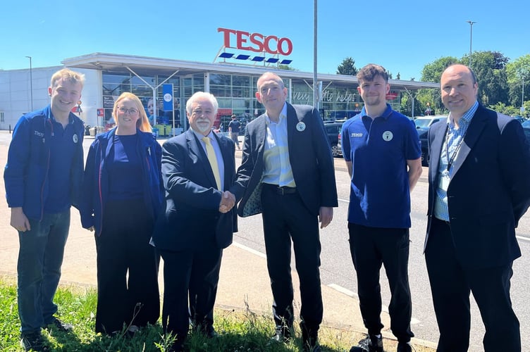 Councillor Steve Keable, third from left, shakes hands with Cullompton's Tesco manager Grant Day