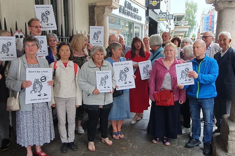 Northbrook swimming pool protesters with signs reading 'Don't be a fool... save our pool!'