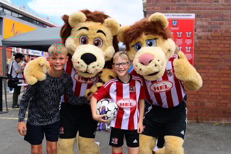 Grecian and Lexi the Lion pose with fans  during the Exeter City Party at the Park in 2023