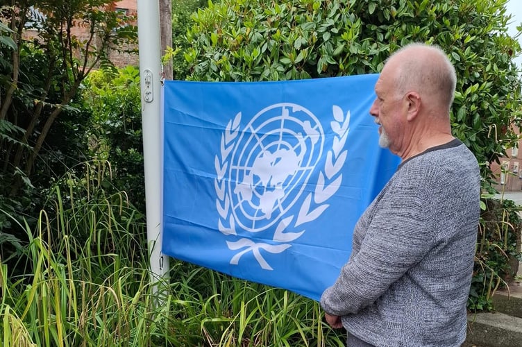 Crediton Mayor Cllr Steve Huxtable with the United Nations flag.
