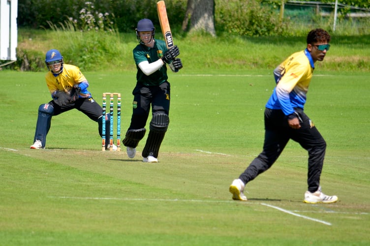 Sandford keeper Adam Small and bowler Praison Alias can only admire Cornwood captain Elliott Staddon belting the bowling for four 